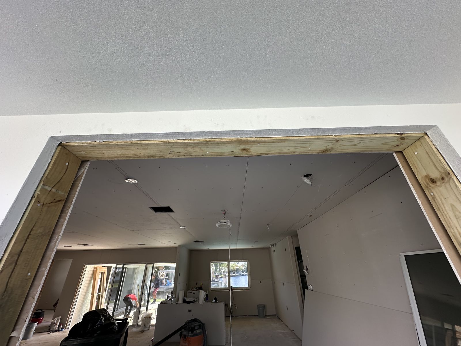 New pressure-treated wood buck framing a wide window opening during a renovation