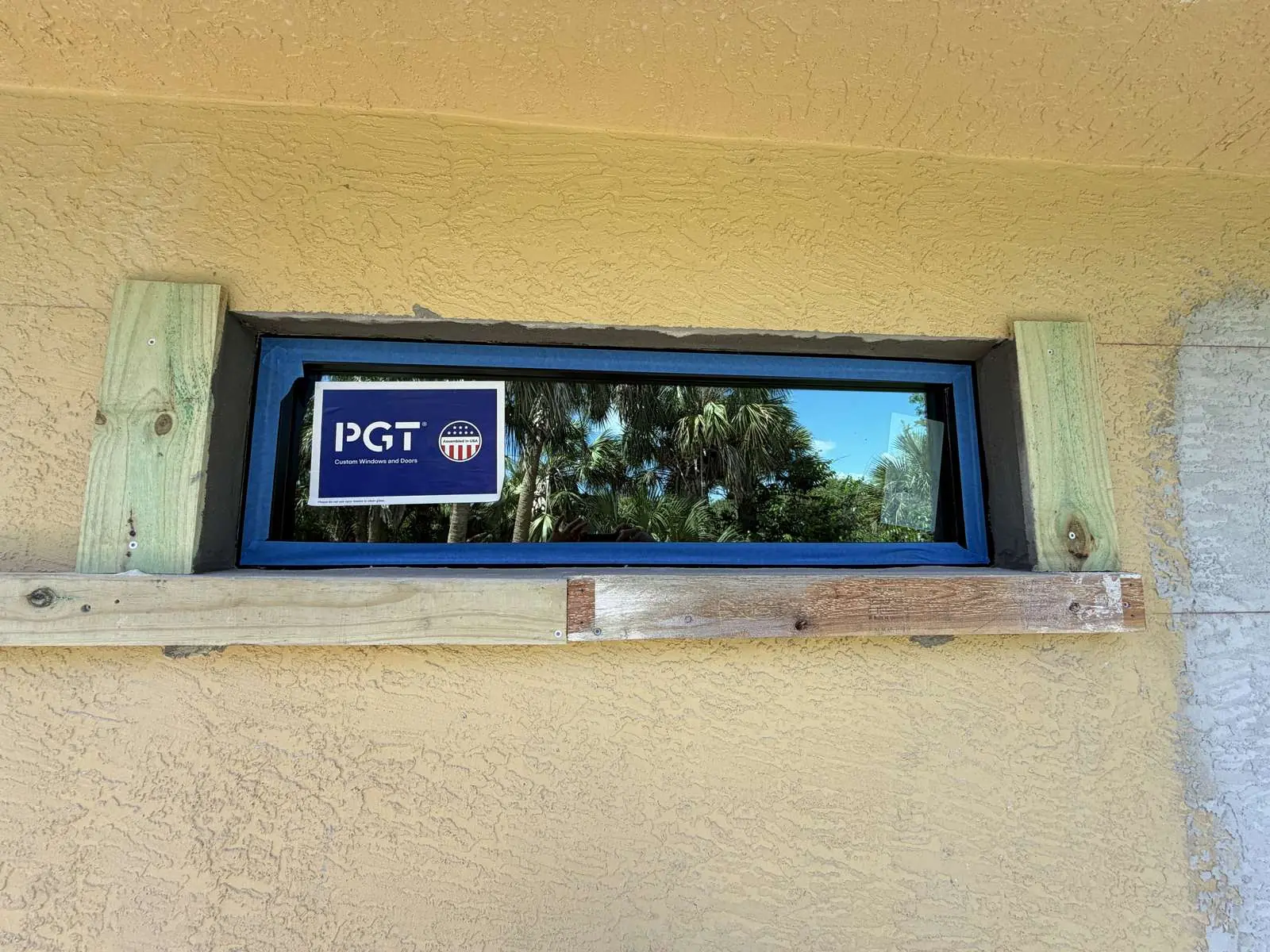 PGT impact transom window set in a wood buck before finishing