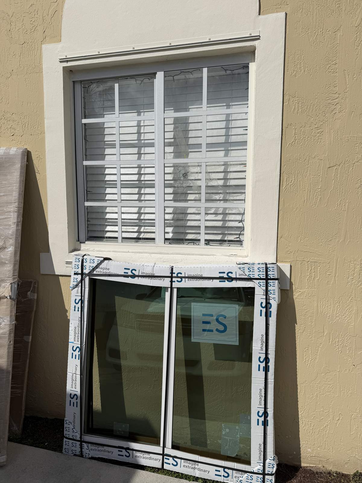 New ES impact window in packaging below the old barred window it will replace